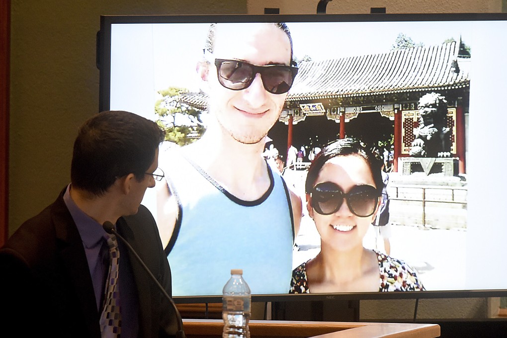 During his trial in Columbia, Missouri, in November, Joseph Elledge looks at a photo of himself and his late wife Mengqi Ji from a trip they took to China to visit her relatives. Photo: Columbia Daily Tribune via AP