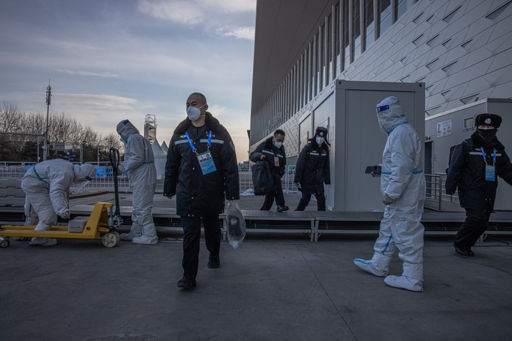 Police and staff in protective gear outside the main media centre in the Beijing Olympics Covid-19 “bubble”. Photo: EPA-EFE