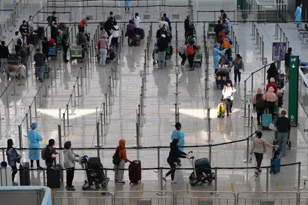 Inbound travellers arrive at Hong Kong International Airport on November 14, 2021, before being transported to quarantine hotels in the city. Photo: May Tse