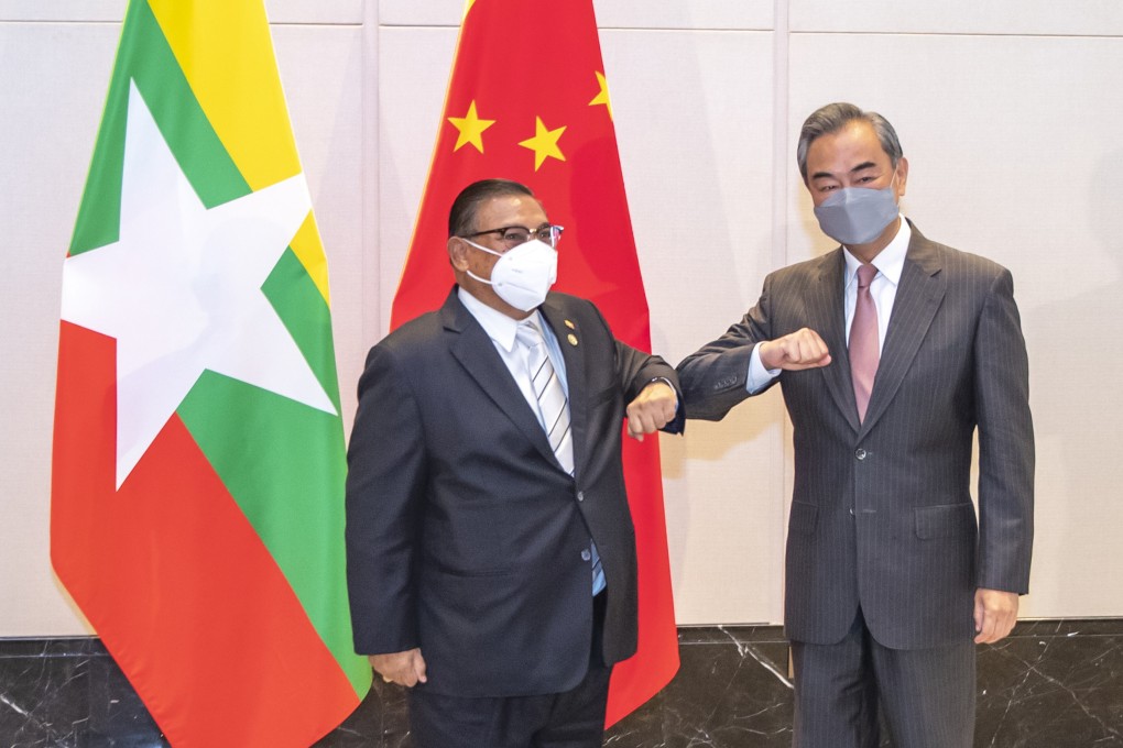 China’s Foreign Minister Wang Yi bumps elbows with with U Wunna Maung Lwin, his counterpart appointed by Myanmar’s junta, in Chongqing in June 2021. Photo: Xinhua via AP