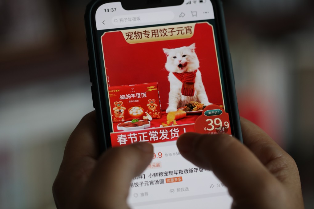 A woman searches for Lunar New Year meal for pets on Taobao in Beijing on January 27, 2022. Festive food designed specifically for pets are gaining traction among young pet owners on e-commerce platforms in China. Photo: Simon Song