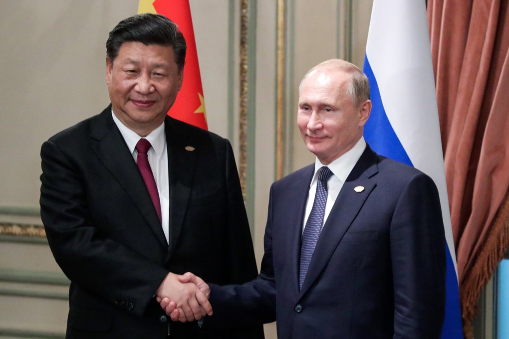 China’s President Xi Jinping, left, shakes hands with Russian President Vladimir Putin in November 2018. File photo: Tass/Abaca Press via TNS