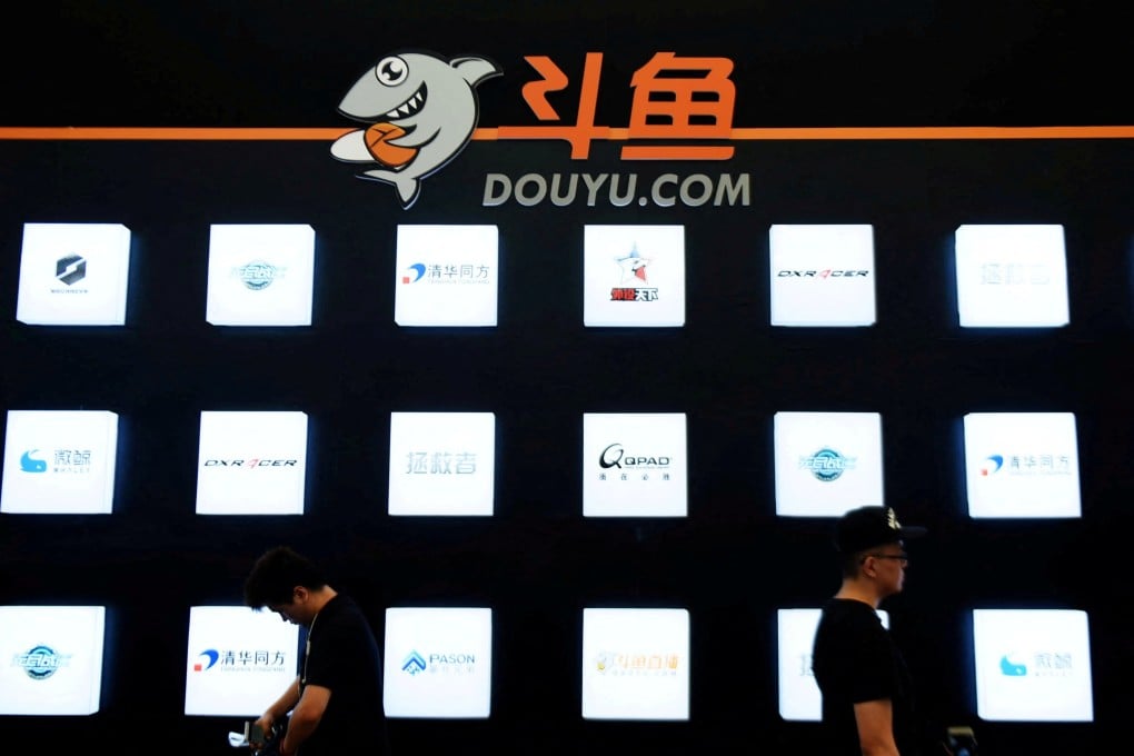People walk past a booth of live-streaming platform Douyu at the ChinaJoy digital entertainment expo in Shanghai on July 28, 2016. Photo: Reuters