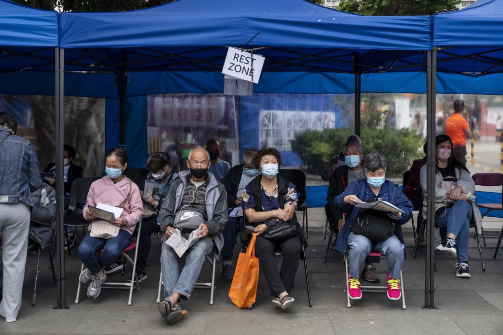 Residents wait at a rest area after receiving a vaccine at a mobile vaccination station in Hong Kong. Photo: Anadolu Agency via Getty Images