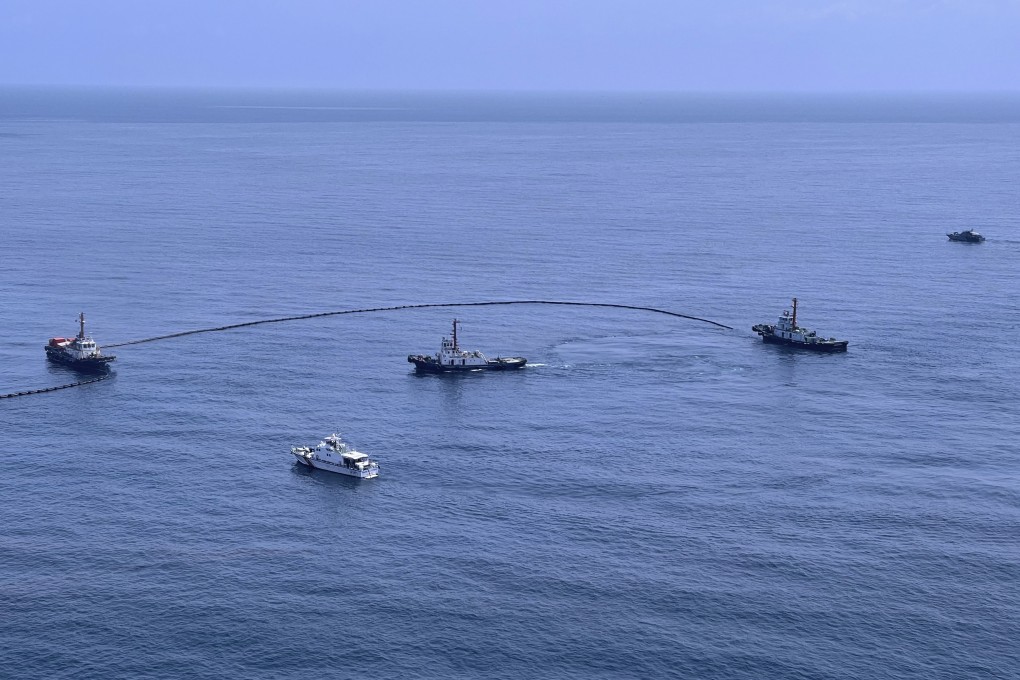 An aerial view from a navy plane shows clean-up efforts of a large oil spill off the coast of Rayong, eastern Thailand on Thursday. Photo: Royal Thai Navy via AP
