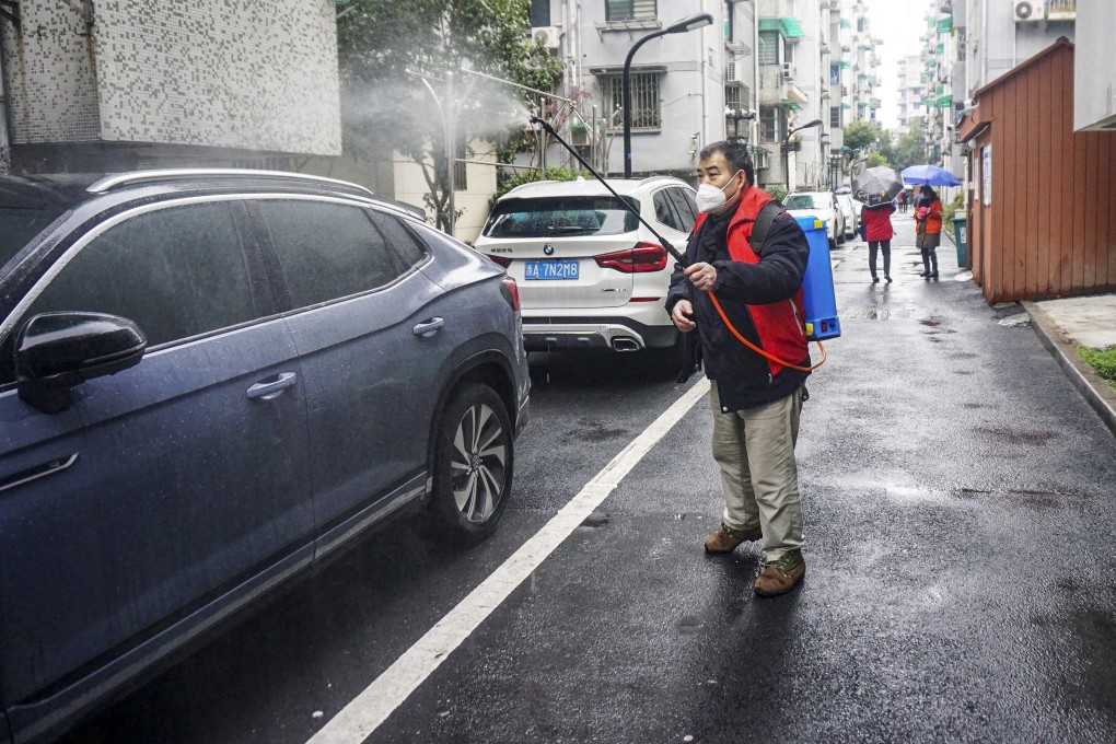 On Friday, a worker sprays disinfectant in a residential area which is restricted because of a recent Covid-19 outbreak in Hangzhou, in China’s eastern Zhejiang province. Photo: AFP