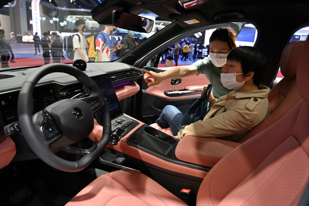 Customers checkout NIO’s EC6 car at the Shanghai International Automobile Industry Exhibition in April last year. Photo: AFP