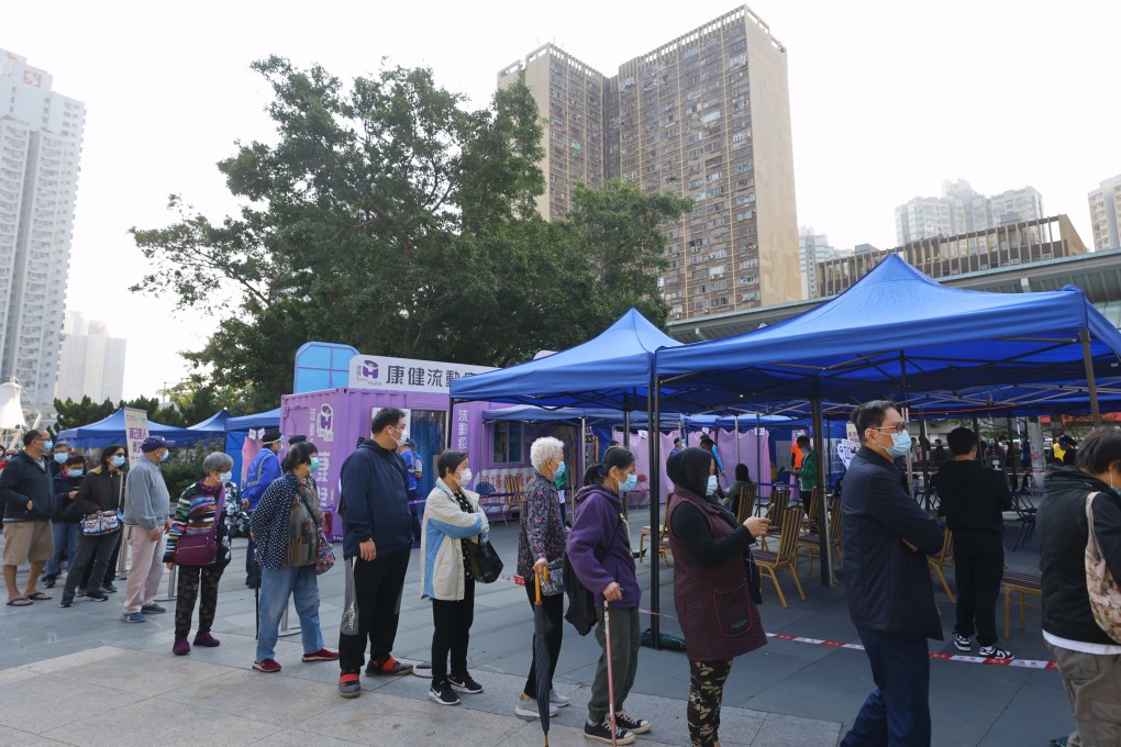 Residents line up for a Covid-19 shot at a mobile vaccination station in Hong Kong. Photo: Dickson Lee