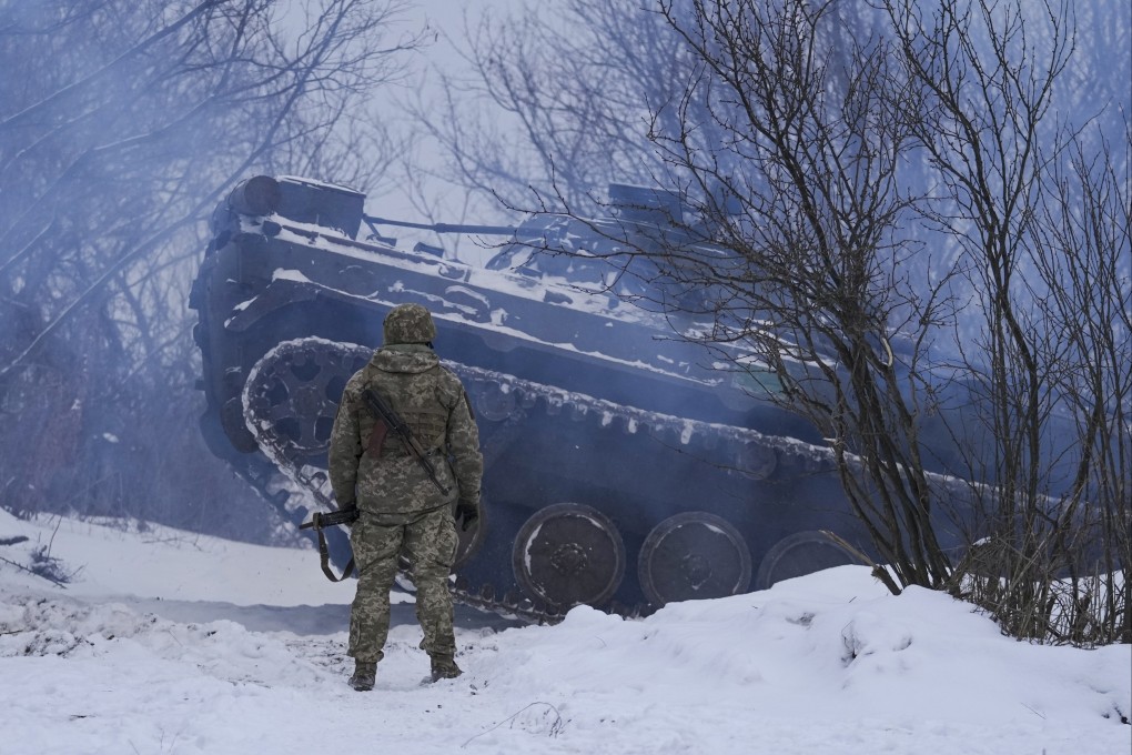 An Ukrainian serviceman watches an armoured personnel carrier get in position in the Luhansk area on Friday. Photo: AP