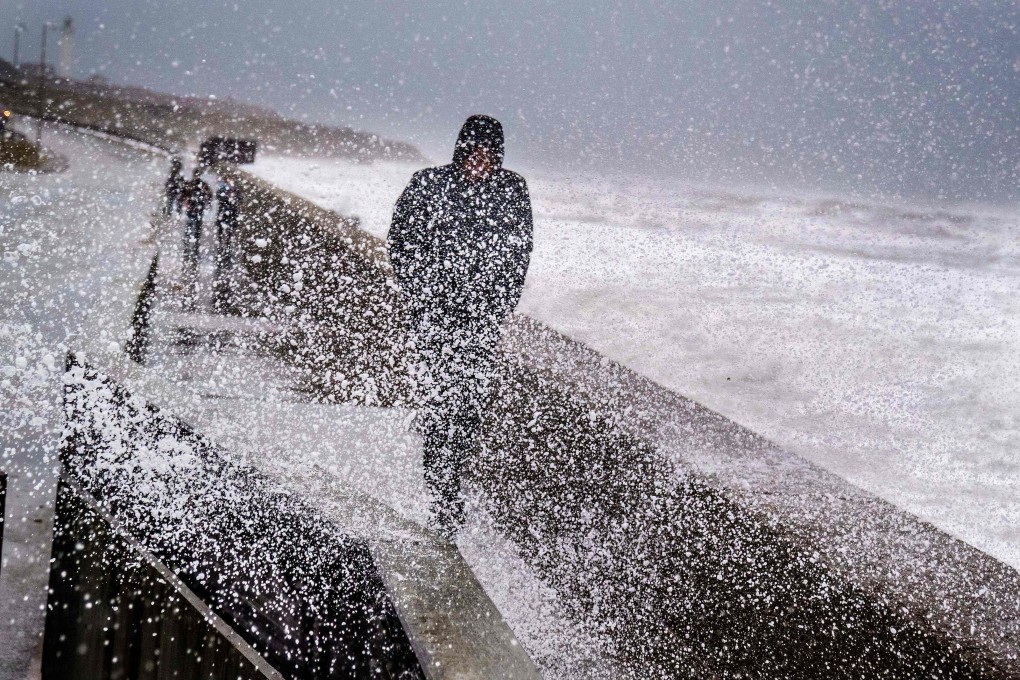 A man walks along the waterfront in the Harbour of Hirtshals, Denmark as Storm Malik hits the Northern Jutland West Coast on January 29. Photo: AFP