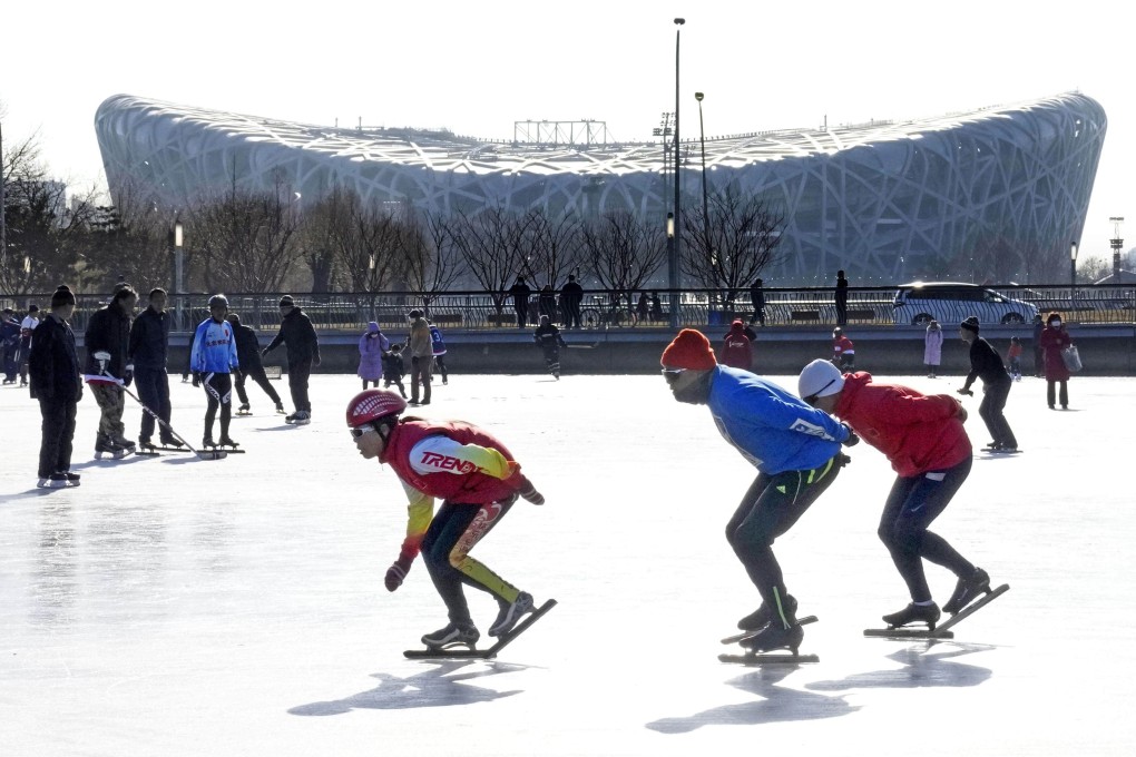 People skate at an outdoor ice rink in Beijing on January 3, 2022. Seen in the background is the National Stadium, the venue of the opening ceremony of the Beijing Winter Olympics. Photo: Kyodo