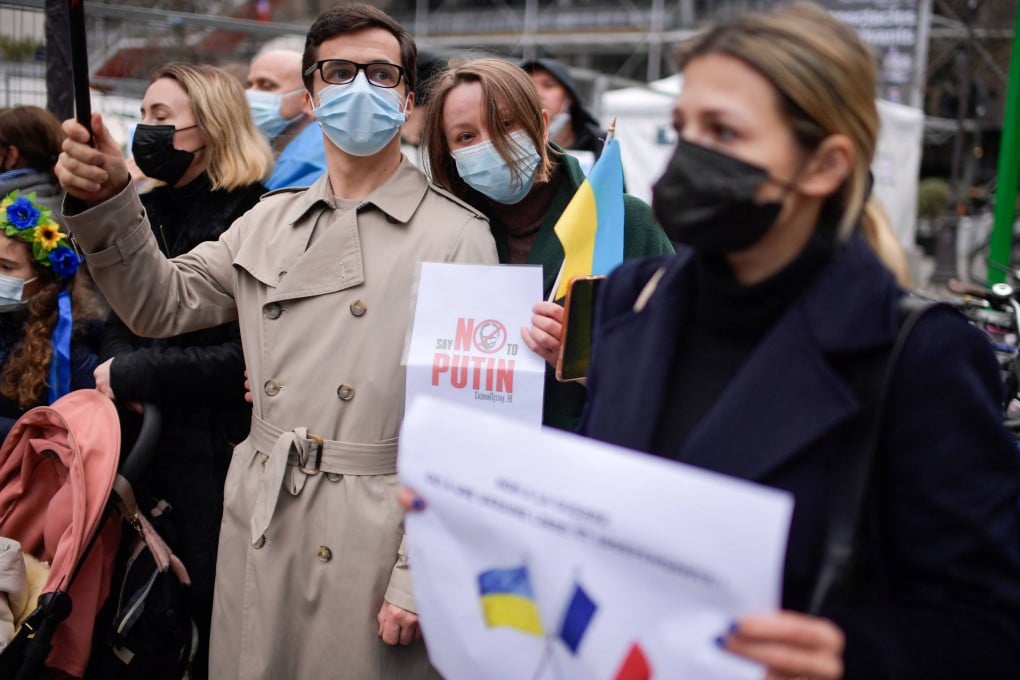 Protesters hold signs and Ukrainian flags during a demonstration in Paris on January 29 in support of Ukraine. Photo: AFP