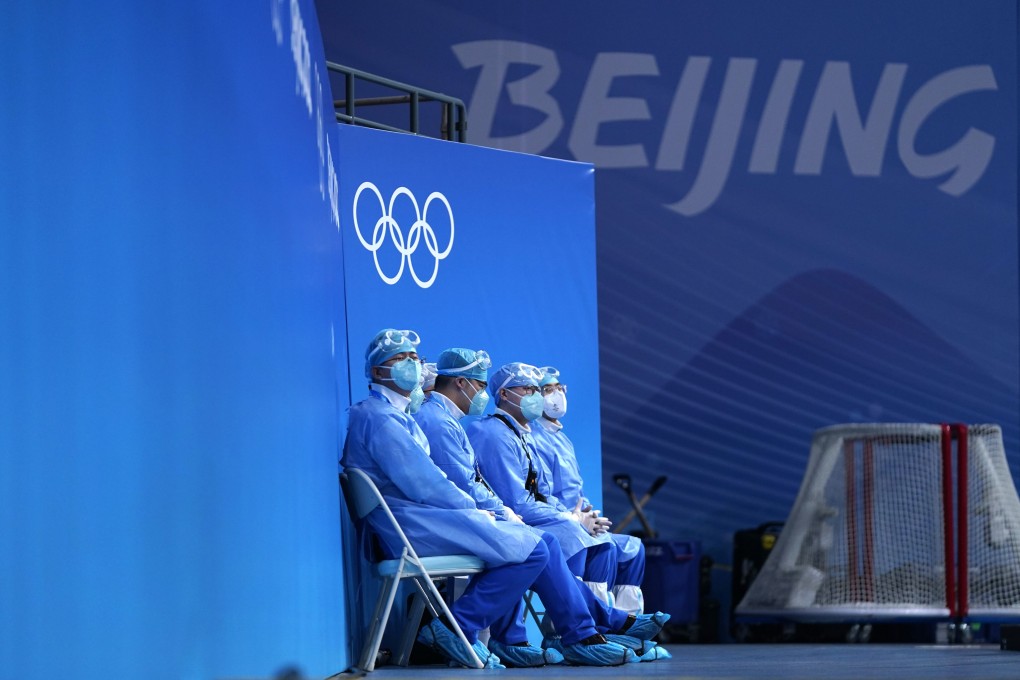 Medical personnel watch as Canada’s women’s hockey team practice in Beijing. Photo: AP