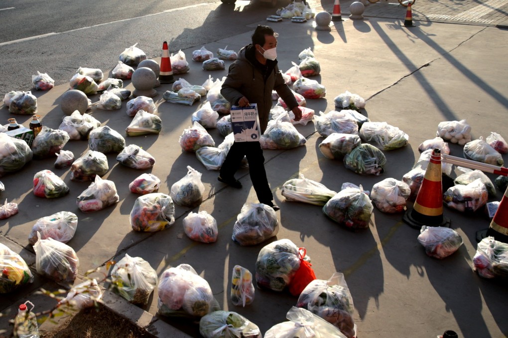 A worker prepares food supplies to be delivered to residents of a compound under lockdown in Xian, Shaanxi province, late last year. Photo: Reuters
