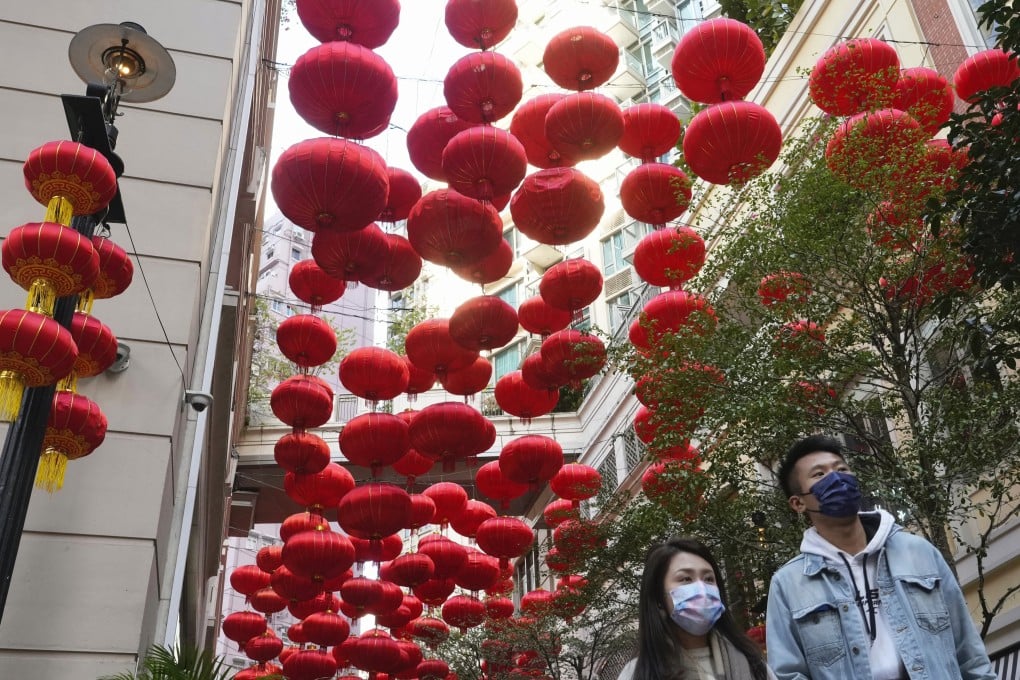 People walk past decorations to celebrate the Lunar New Year in Hong Kong on January 30. Photo: AP