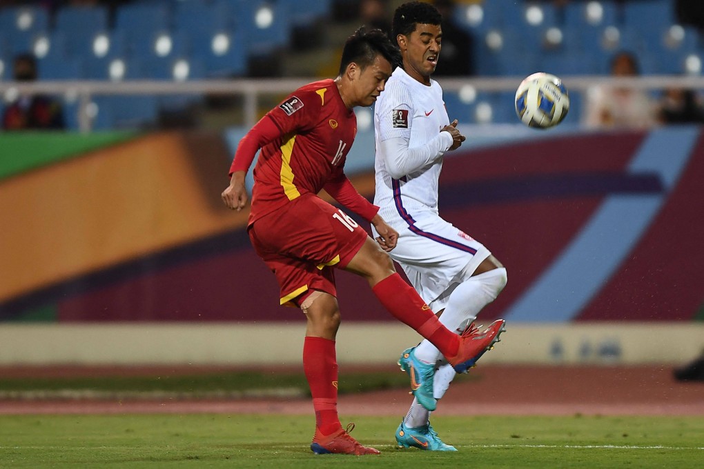 Vietnam’s Nguyen Thanh Chung and China’s A Lan fight for the ball during their Fifa World Cup Qatar 2022 qualifying match at My Dinh National Stadium in Hanoi on Tuesday. Photo: Nhac Nguyen/AFP