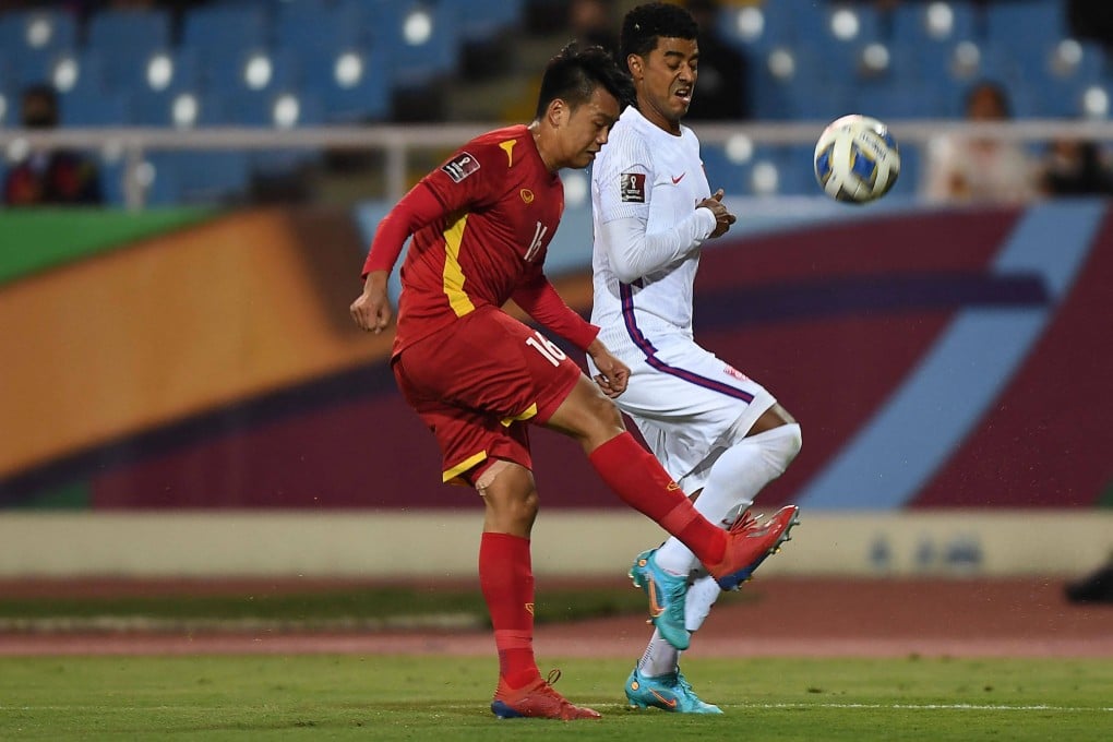 Vietnam’s Nguyen Thanh Chung and China’s A Lan fight for the ball during their Fifa World Cup Qatar 2022 qualifying match at My Dinh National Stadium in Hanoi on Tuesday. Photo: Nhac Nguyen/AFP