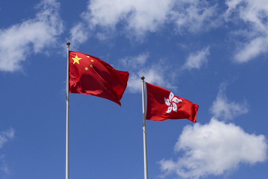 The national and Hong Kong flags flutter in Central. Photo: David Wong