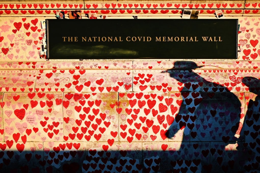The shadow of a pedestrian cast across the Covid-19 Memorial Wall in London. A new study involving healthy young people being deliberately infected with the original strain of the virus in order to advance research has been successful. Photo: EPA-EFE