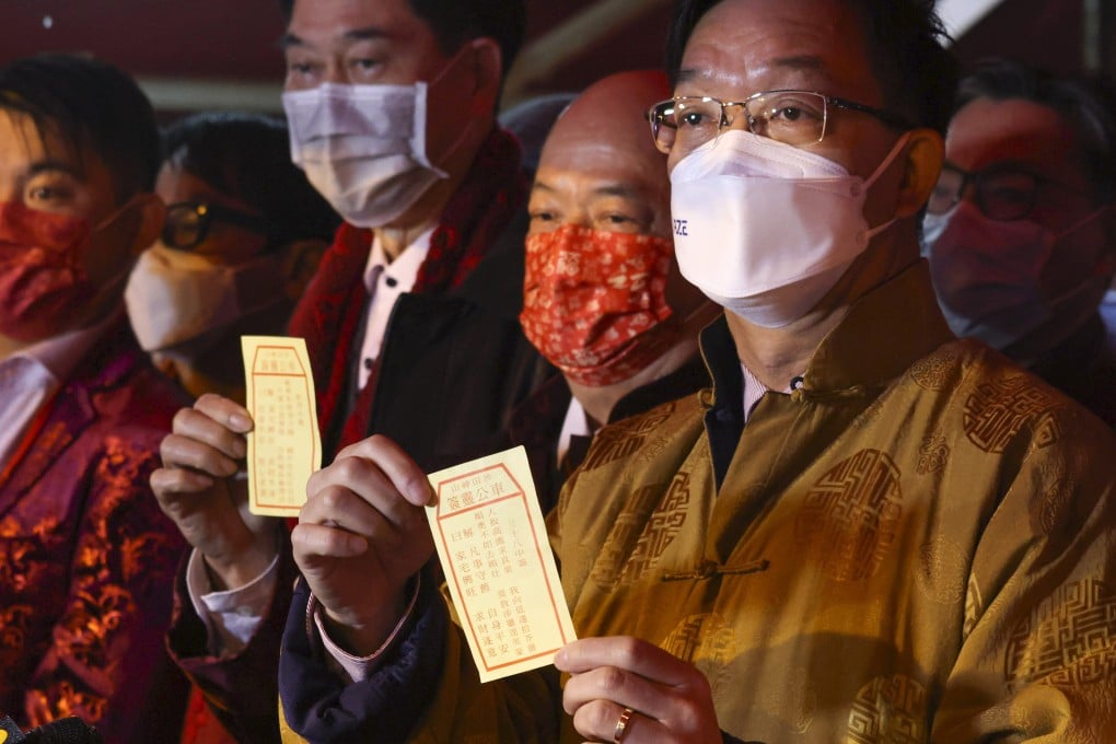 Heung Yee Kuk chairman Kenneth Lau (right) drew the neutral No 38 fortune stick for Hong Kong during an annual Lunar New Year ritual on Wednesday. Photo: Nora Tam
