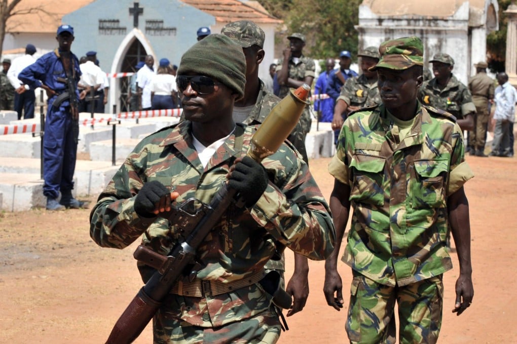 A soldier carries a rocket launcher during the state funeral of slain Guinea-Bissau president Joao Bernardo Vieira in March 2009. The country has a long history of military takeovers. Photo: AFP