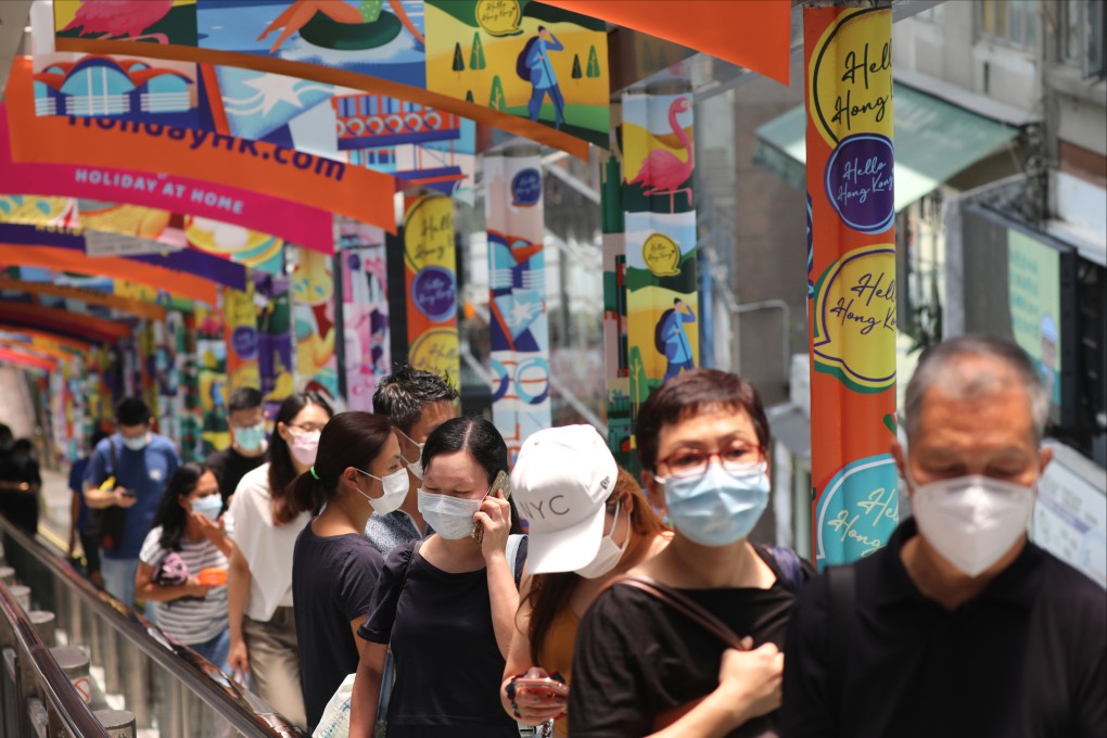 People in masks stand on the Mid-Levels escalator in Central in 2020. Photo: Nora Tam