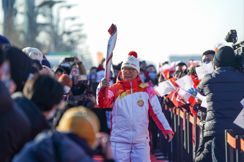 Luo Zhihuan, China’s first winter sports champion, was the first torch-bearer on the three-day trek through Beijing. Photo: Xinhua