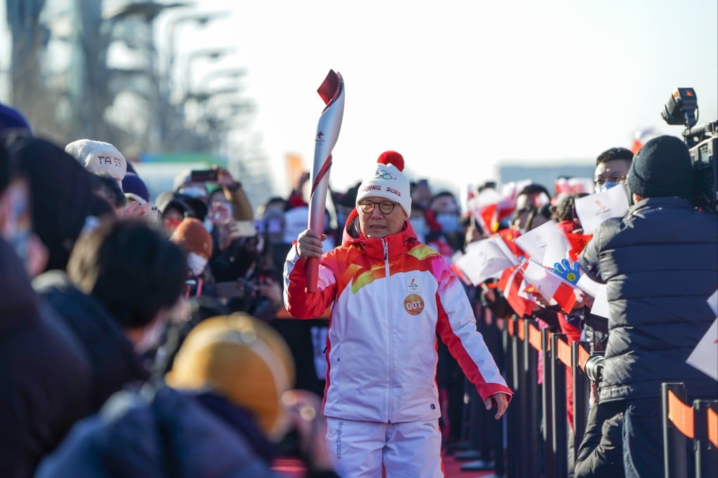 Luo Zhihuan, China’s first winter sports champion, was the first torch-bearer on the three-day trek through Beijing. Photo: Xinhua