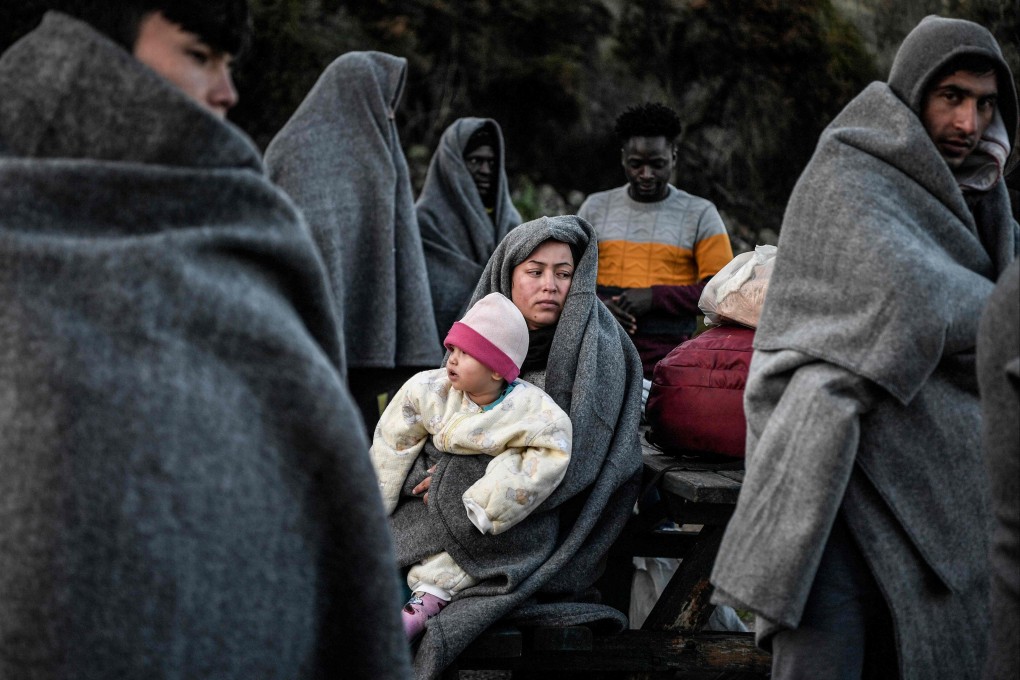 Migrants and refugees arriving from Turkey on the Greek island of Lesbos try to keep warm in 2020. Turkey’s Interior Minister said on Wednesday that 12 migrants had been found frozen to death near Turkey’s border with Greece. File photo: AFP