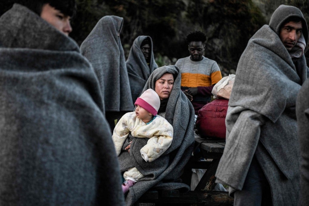 Migrants and refugees arriving from Turkey on the Greek island of Lesbos try to keep warm in 2020. Turkey’s Interior Minister said on Wednesday that 12 migrants had been found frozen to death near Turkey’s border with Greece. File photo: AFP