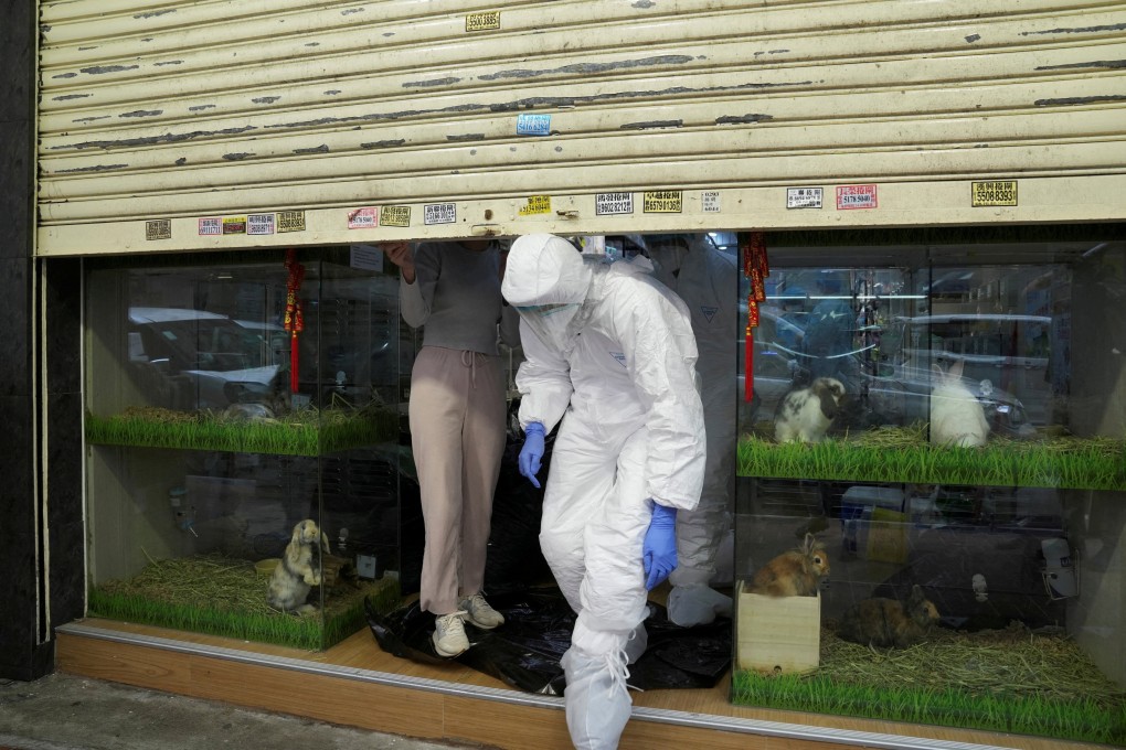 Officers in protective suits leave a closed pet shop in Hong Kong’s Mong Kok district after a hamster cull was ordered to curb the coronavirus disease outbreak, on January 19. Photo: Reuters