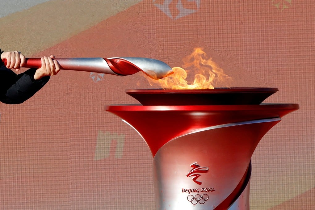 An Olympic torch is lit from the cauldron ahead of the relay in Beijing. Photo: Reuters