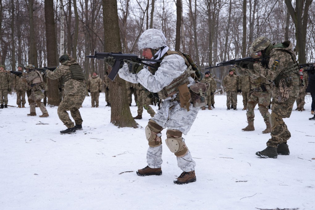 Volunteers in a Kyiv Territorial Defence unit train in a forest near Kyiv, Ukraine, on January 22. Across Ukraine, thousands of civilians are participating in such groups to receive basic combat training and, in time of war, would be under direct command of the Ukrainian military. Photo: TNS