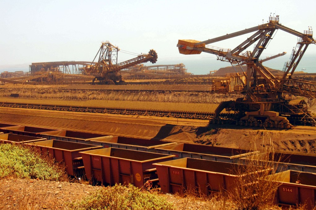 Stackers and reclaimers move iron ore to rail cars in Western Australia’s Pilbara region. File photo: AFP