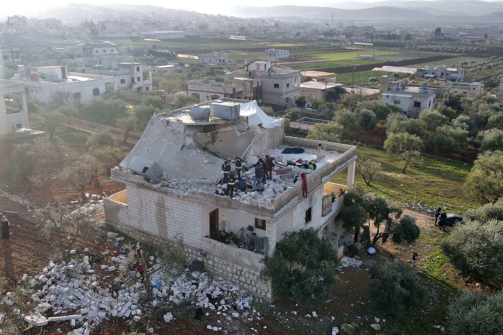 Syrians gather on Thursday at the scene following an overnight raid by US special operations forces in northwestern Syria. Photo: AFP