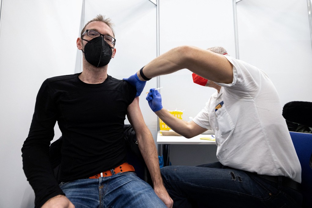 A man gets a dose a Covid-19 vaccine, one day before the start of compulsory vaccinations in Austria. Photo: Reuters
