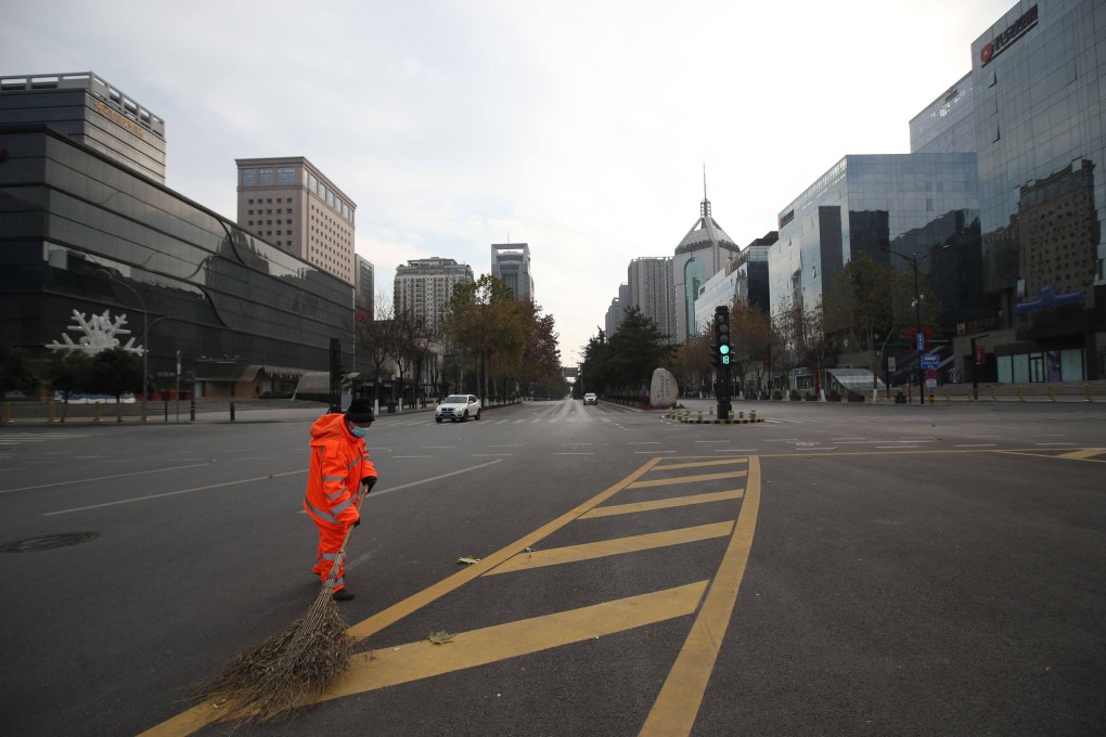 A sanitation worker sweeps a deserted road during a  coronavirus lockdown in Xian, in China’s Shaanxi province. Photo: AFP