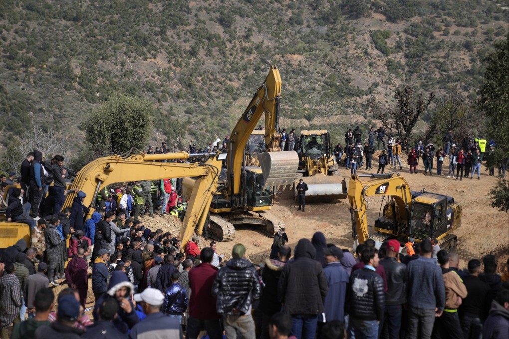 Residents watch civil defense workers and local authorities attempt to rescue a five-year-old boy who fell into a well near Chefchaouen, Morocco on Friday. Photo: AP