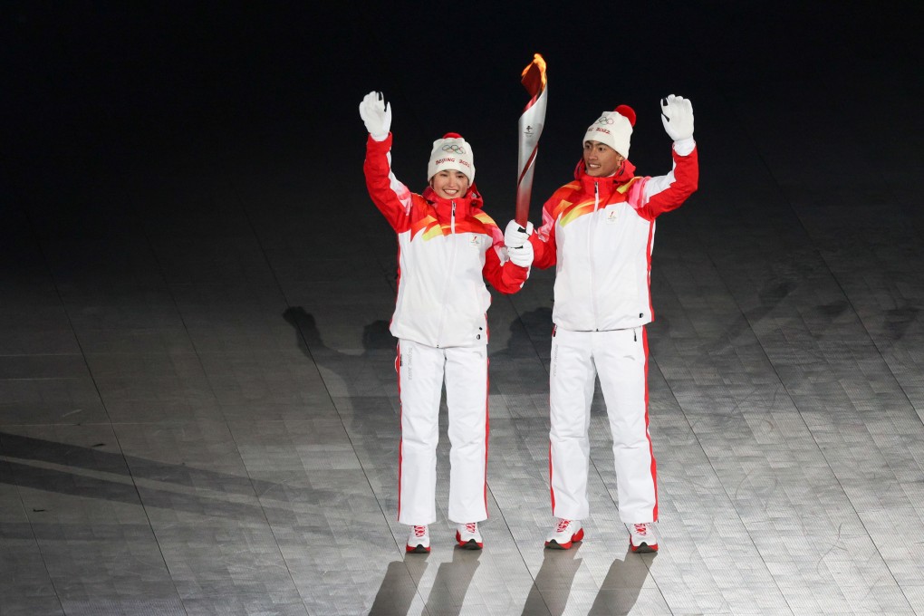 (220205) -- BEIJING, Feb. 5, 2022 (Xinhua) -- Torch bearers Dinigeer Yilamujiang (left) and Zhao Jiawen at the opening ceremony of the Beijing 2022 Olympic Winter Games. Photo: Xinhua