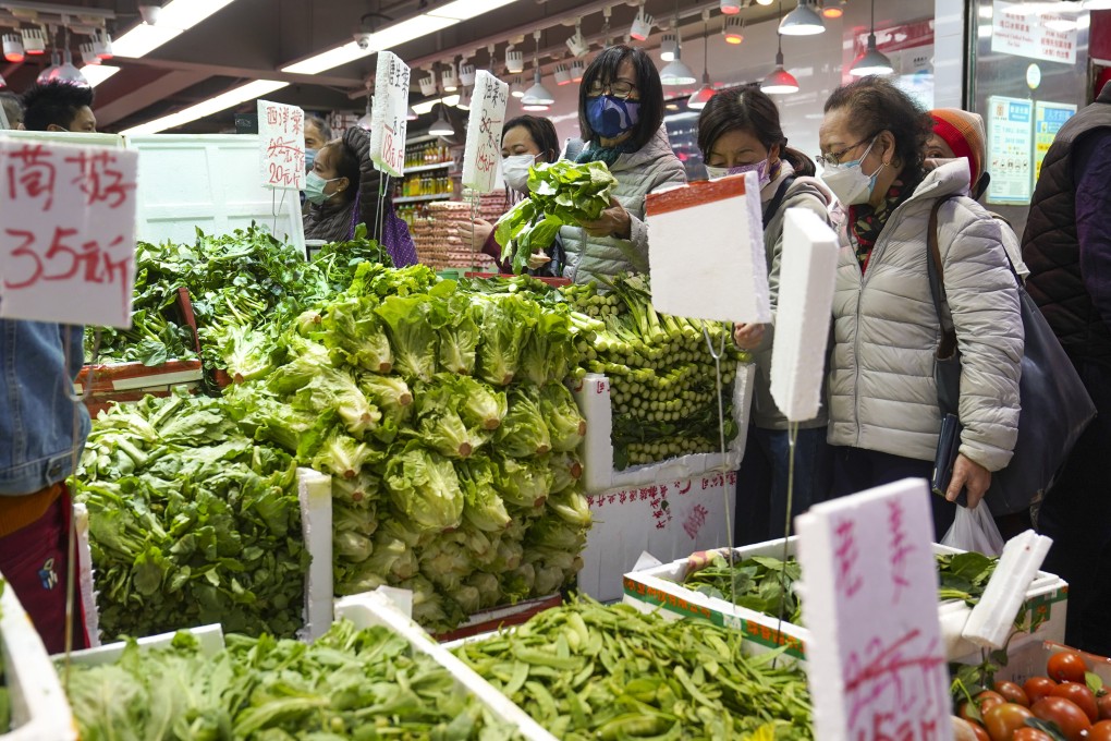 Shoppers buy vegetables at a wet market in North Point, as the reduced supply causes the prices of some staple vegetables to increase. Photo: Sam Tsang