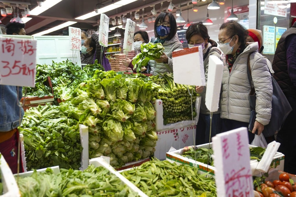Shoppers buy vegetables at a wet market in North Point, as the reduced supply causes the prices of some staple vegetables to increase. Photo: Sam Tsang