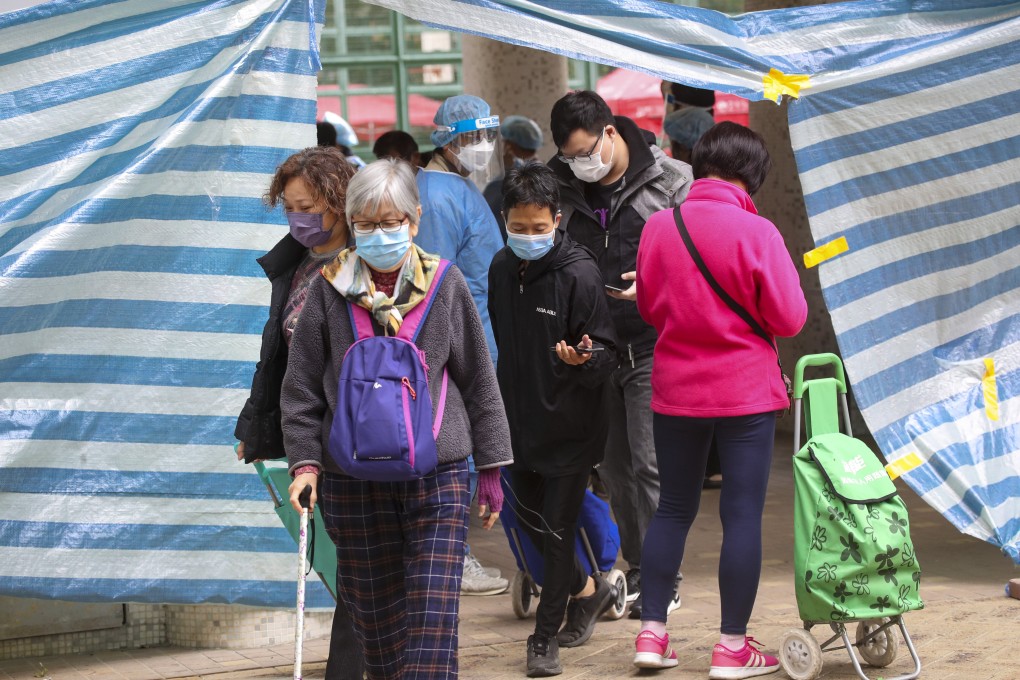 Residents leave Fu Yuet House at Fu Cheong Estate on Wednesday after a lockdown testing operation. Photo: Edmond So