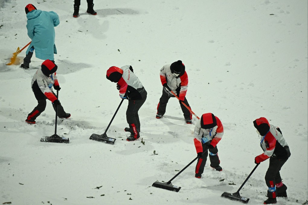 Staff work on the course during freestyle skiing training at the Genting Snow Park in Zhangjiakou, ahead of the Beijing 2022 Winter Olympics. Photo: Reuters/Dylan Martinez