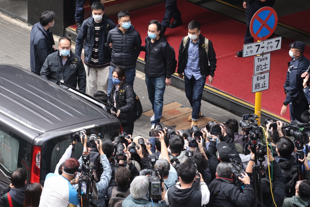 Police escort Stand News acting editor-in-chief Patrick Lam from the outlet’s office last month. photo: May Tse