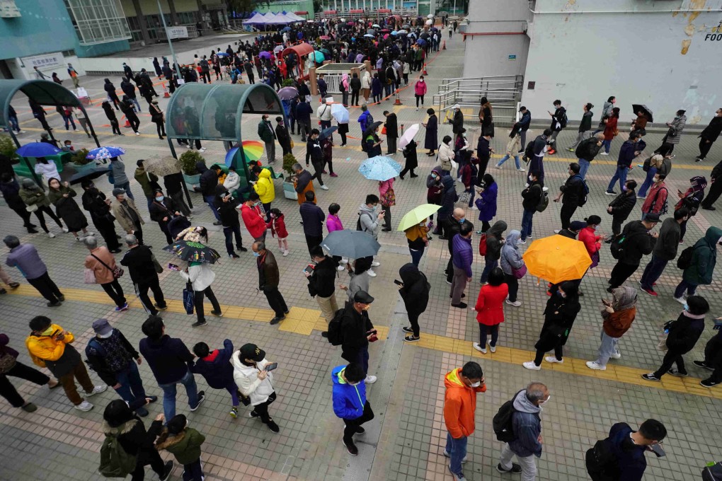 People wait in line for Covid-19 tests at a mobile testing station in Lek Yuen Community Hall. The number of cases in the city is rising exponentially. Photo: Felix Wong