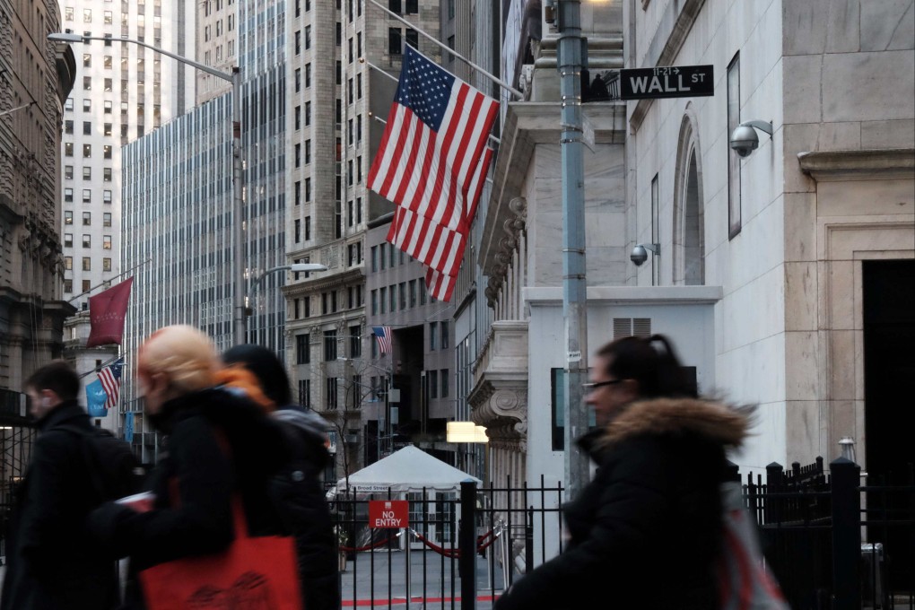 People walk by the New York Stock Exchange (NYSE) in the Financial District on January 26 in New York City. Photo: Getty Images via AFP