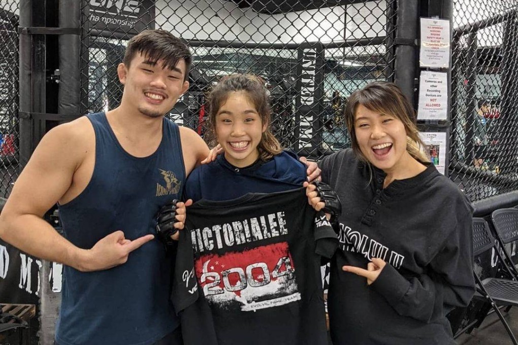 Christan Lee (left) and Angela Lee (right) celebrate with younger sister Victoria Lee after she signs with Evolve MMA. Photo: Instagram/@victorialeemma