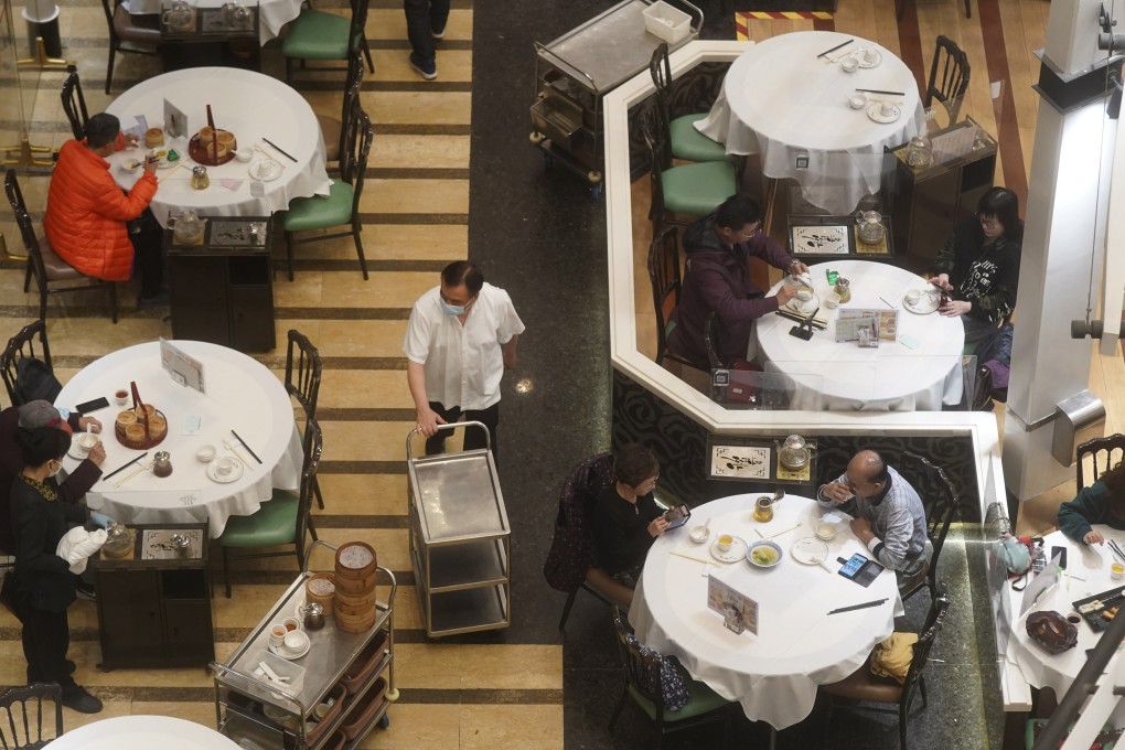 People dine in a Chinese restaurant in Tsing Yi. The cap on public gatherings has been tightened to two people. Photo: Sam Tsang