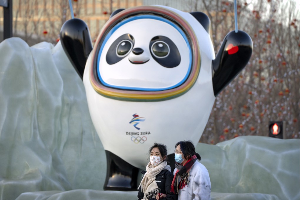 Pedestrians walk past the Winter Olympics mascot Bing Dwen Dwen in Beijing. Official NFTs of the panda will be open for sale, but not in China. Photo: AP Photo