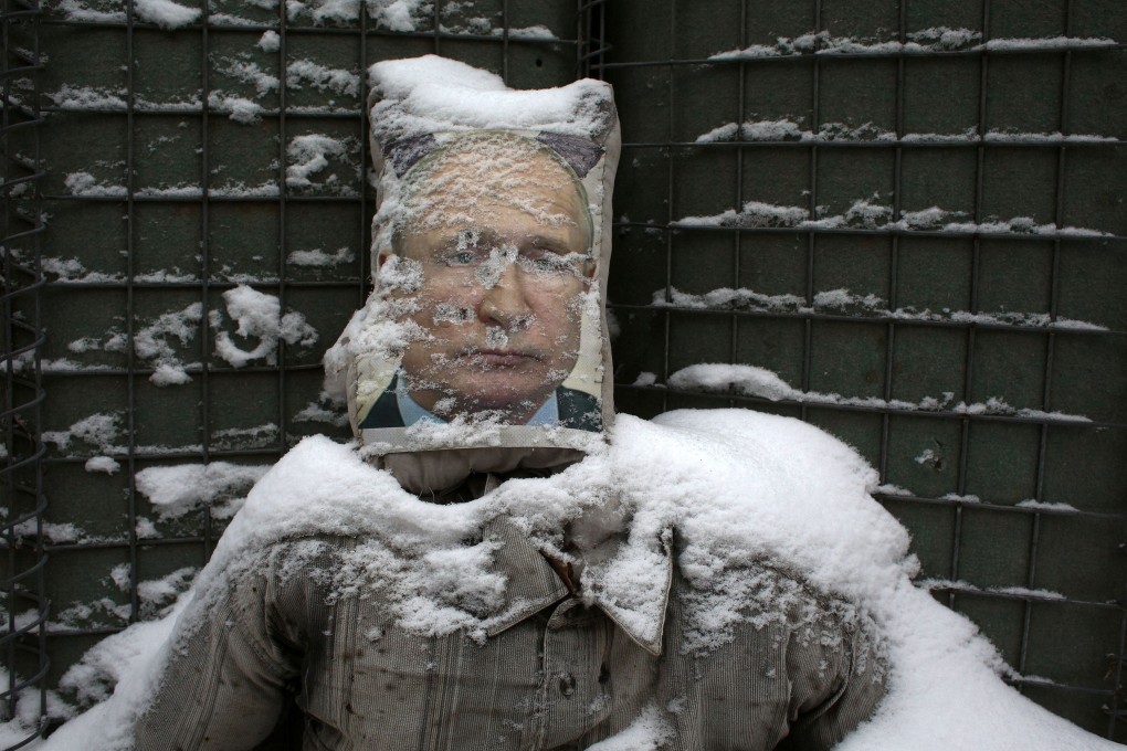 A poster of Russian President Vladimir Putin is used as target practice along a trench on the frontline with Russia-backed separatists near Zolote village, in the Lugansk region. Photo: AFP